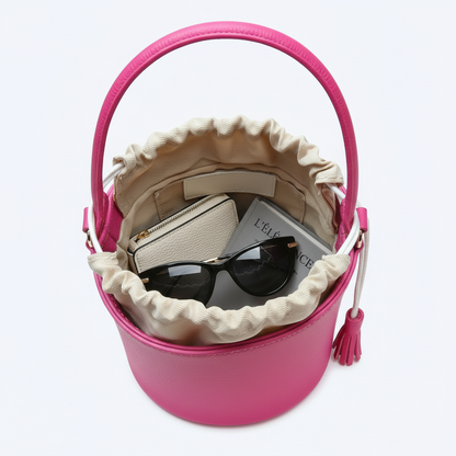Sac fuchsia avec poignée et accessoires visibles